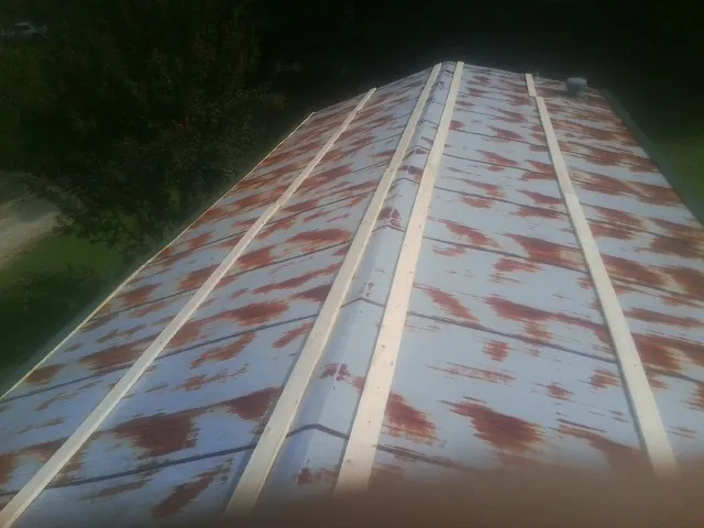 Rusted metal roof panels with new wood purlins before replacement — Storm Damage Roof Repair in Wantagh by Roofing Brothers