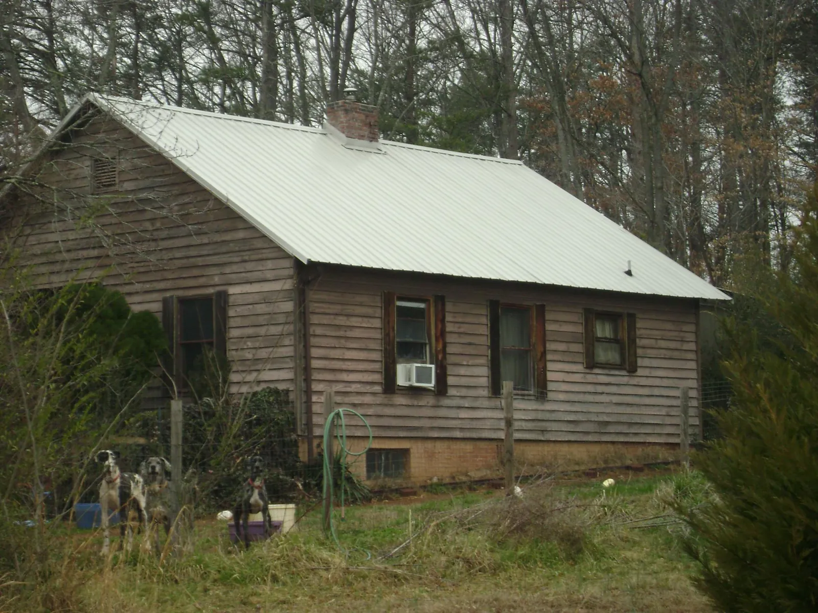 White metal roof on an old wood sided farmhouse, from a Metal Roof Installation job in Wantagh